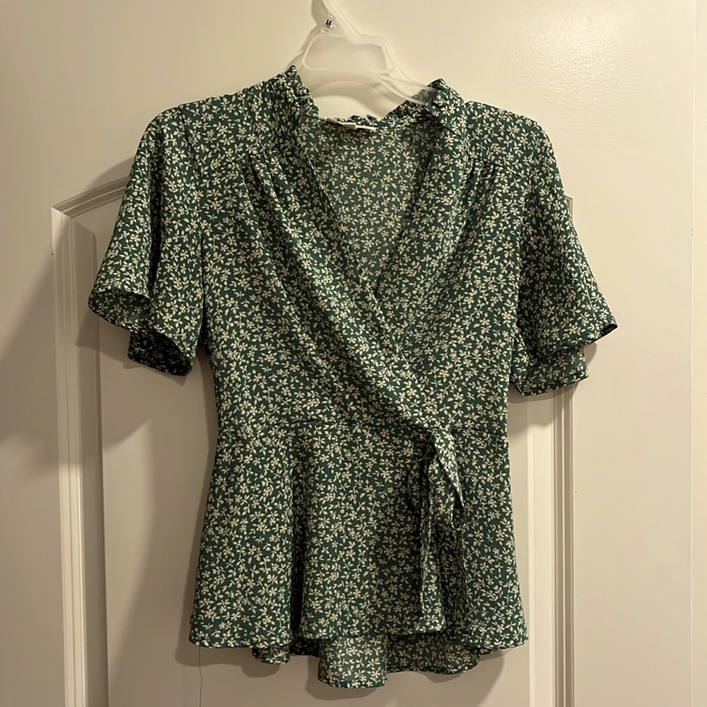 Green v-neck top with white flowers